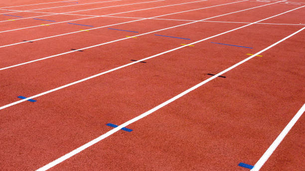 istock red running track on athletic stadium background texture 913625698