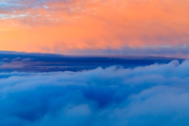 istock Colorful fluffy clouds outside an airplane at sunset 913629580