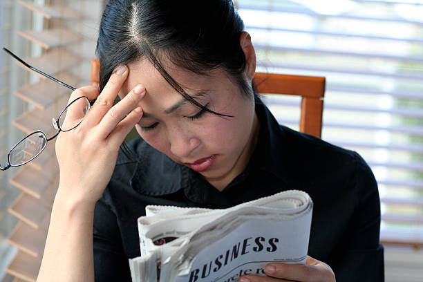 istock Asian woman reading business section 91363327