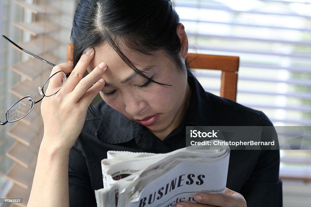 Asian woman reading business section  Adult Stock Photo