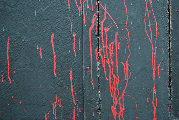 Close Up of Cracked and Peeling Red Paint on a Textured Surface