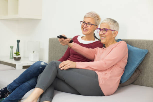 istock Mother and daughter watching television 913634356