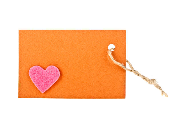 istock Brown paper label witn pink heart on white background 913634934