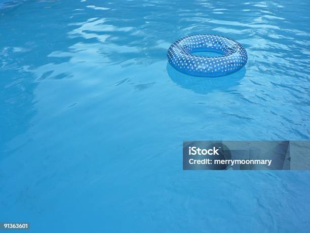 Blue Inner Tube In Swimming Pool 2 Stock Photo - Download Image Now - Floating On Water, Swimming Pool, Tube