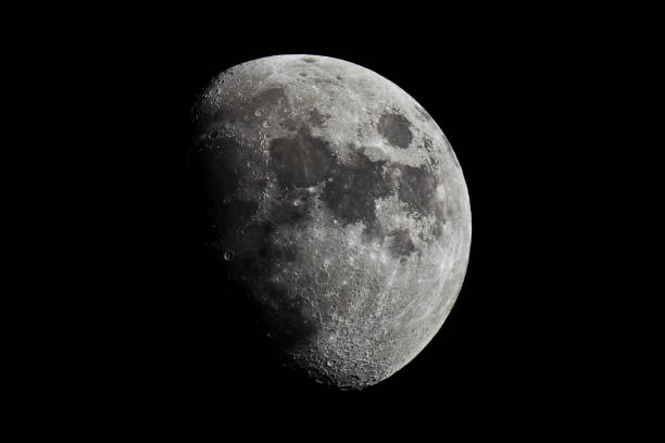 istock Half Moon in the middle of its way on the clear sky. 913638356