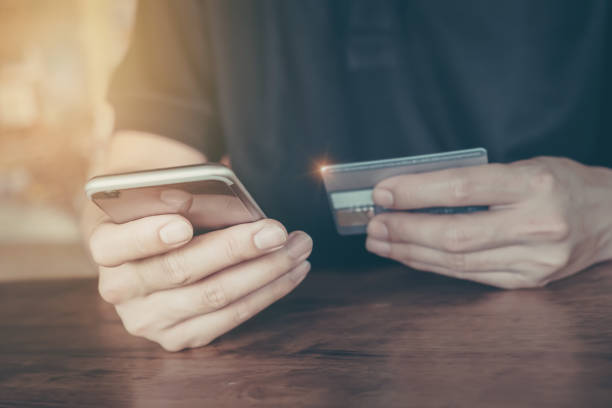 istock Online payment,Man's hands holding smartphone  and using credit 913638408