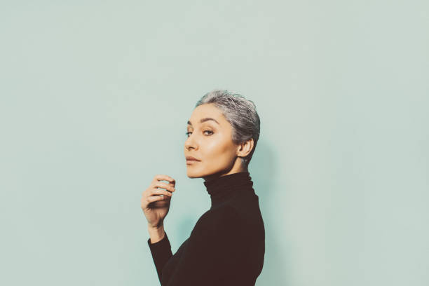 Portrait of a young woman Side view portrait of a young woman with a grey hair, dressed in black gray hair young woman stock pictures, royalty-free photos & images