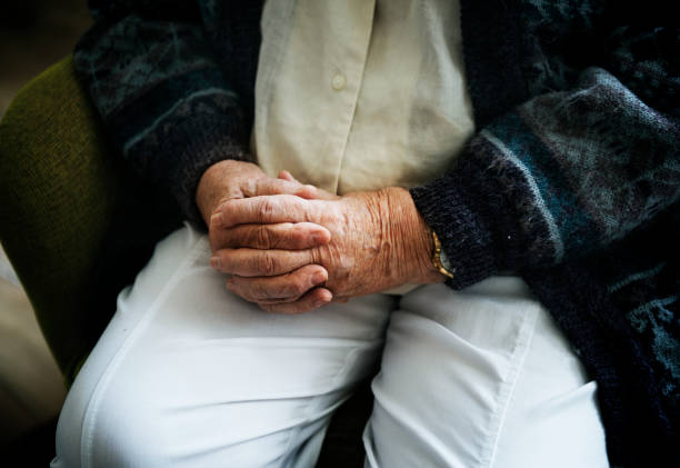 istock Sitting senior man close up on his holding hands 913641838