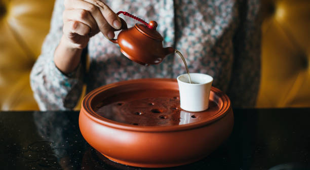 istock Woman pouring tea into a cup 913642056