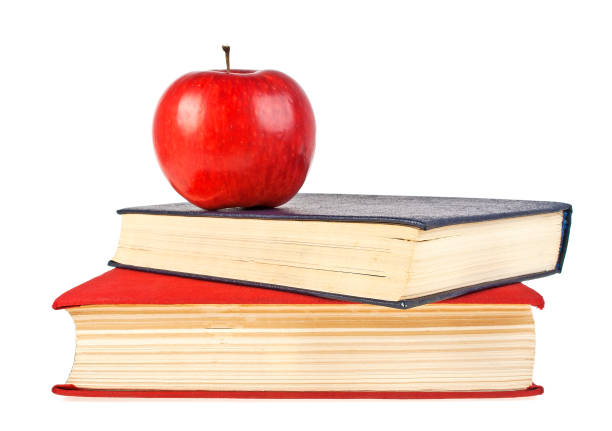 istock Red apple and old books isolated on white background 913644642