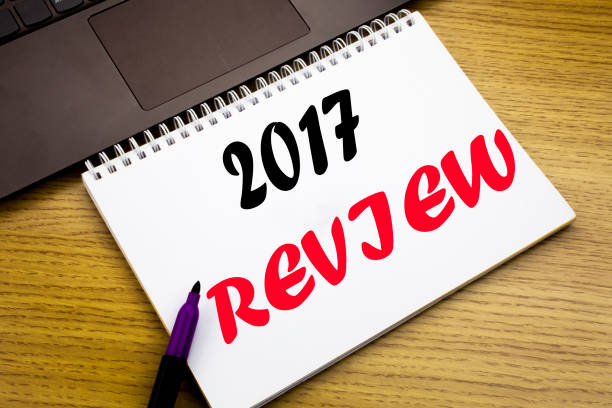 istock Hand writing text caption inspiration showing 2017 Review. Business concept for Annual Summary Report written on notebook book on the wooden background in the Office with laptop 913645002