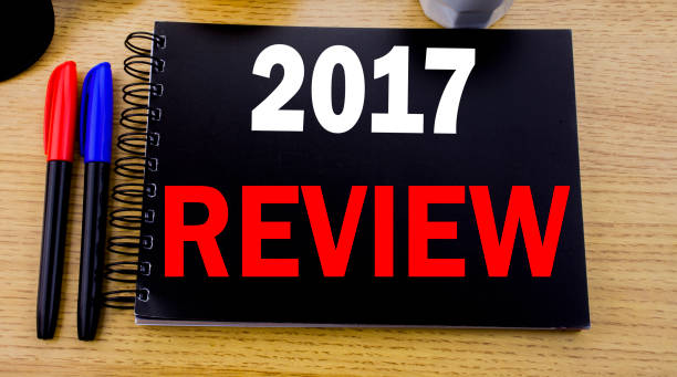 istock Conceptual hand writing text caption showing 2017 Review. Business concept for Annual Summary Report written on sticky note with space on old wood wooden background with sunglasses 913648812