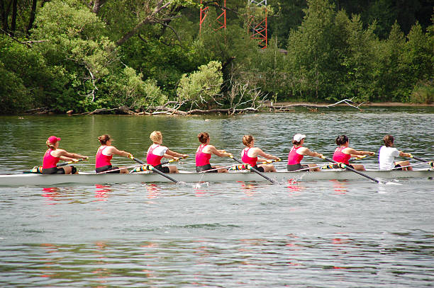 Female rowing team preparing for the next competition  Female rowing team competing in a race. rowing stock pictures, royalty-free photos & images
