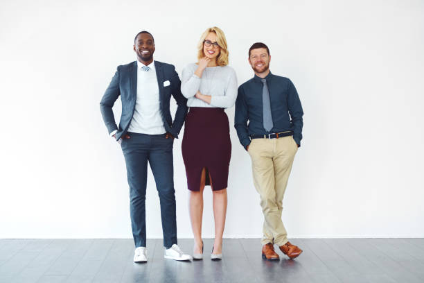 Here today, up there tomorrow! Shot of three well-dressed businesspeople standing against a white background three people stock pictures, royalty-free photos & images