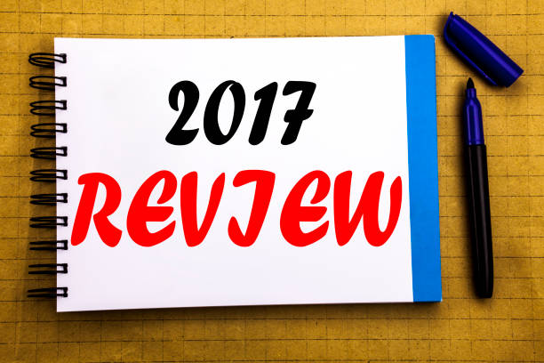 istock 2017 Review. Business concept for Annual Summary Report Written on notepad note paper background with space office view with pencil marker 913650494