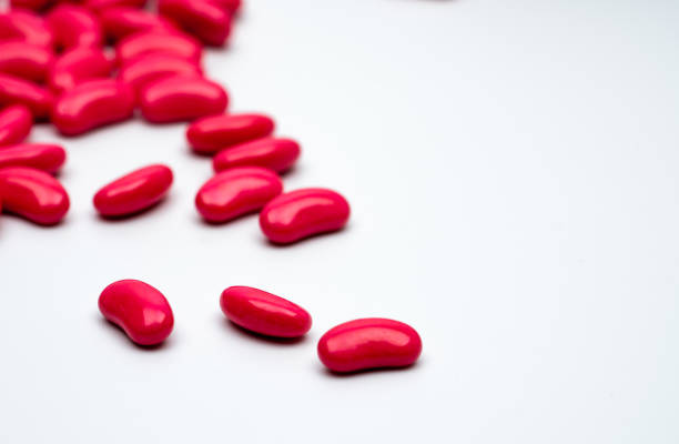 istock Red kidney shape sugar coated tablet pills isolated on white background with copy space for text. 913650572