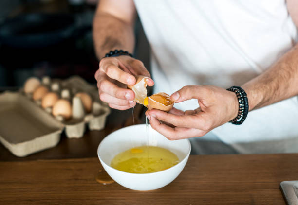 istock Closeup of man separating egg yolk 913654026