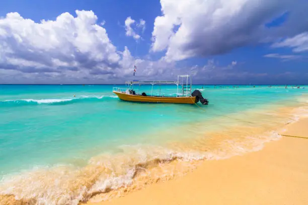 Photo of Yellow speedboat on the beach of Caribbean Sea