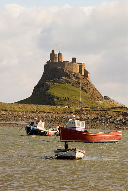 istock Harbour, boats and Lindisfarne Castle 91365932