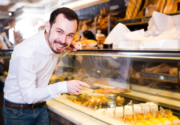 istock Male customer examining desserts 913661418