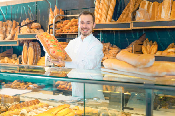 istock Bearded assistant demonstrating festive cake in bakery 913661516