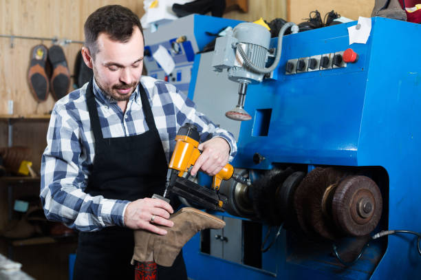istock male worker fixing failed shoes in shoe repair workshop 913661690