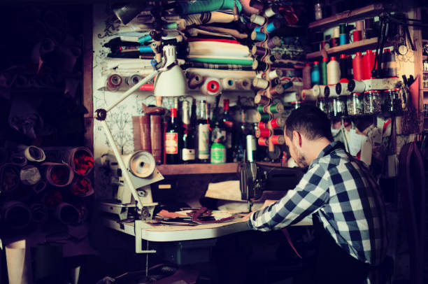 istock Male worker stitching new belt 913661708