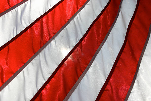 istock Red and white stripes from American flag backlit by sun 91366282