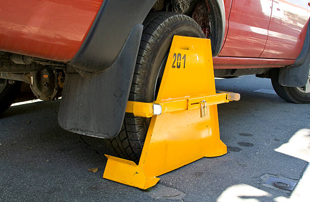 Wheel clamp Clamped car in the restricted parking zone car boot stock pictures, royalty-free photos & images