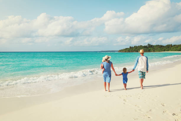 istock happy family with two kids walk on beach 913665350