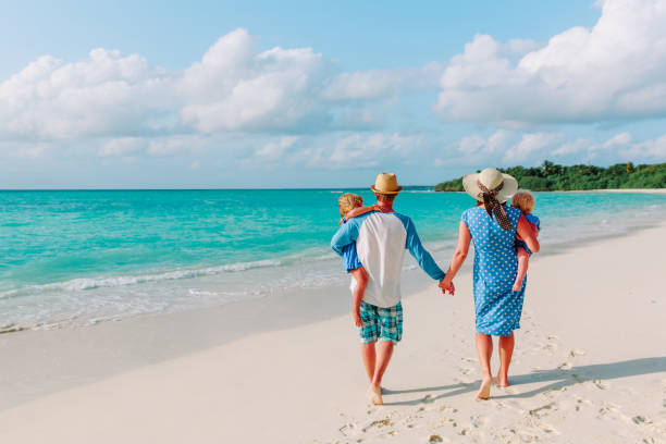 istock happy family with two kids walk on beach 913665410