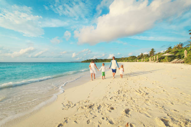 istock happy family with three kids walk on beach 913665642