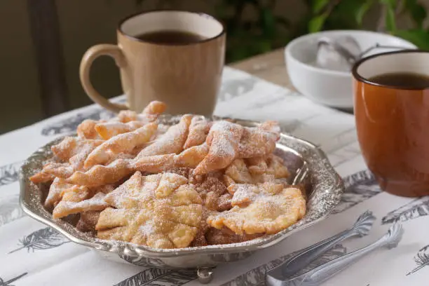 Angel wings biscuits, a traditional European sweet dish for carnival. Rustic style, selective focus.