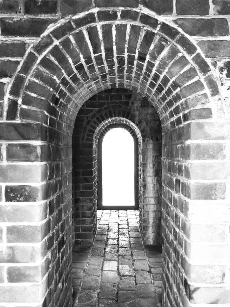 istock Ancient arch in China, old brick wall and floor texture in b/w. 913669552