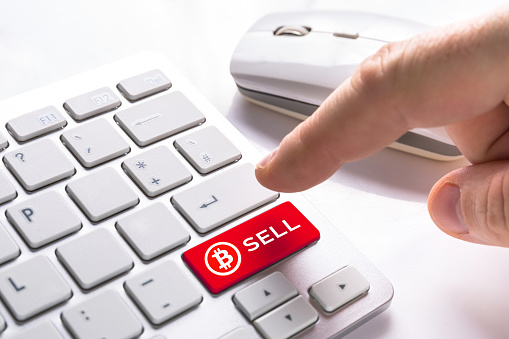 Sell bitcoin currency button on computer keypad