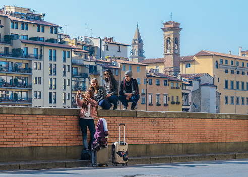 Florence Italy - Oct 30, 2017: Group of young persons taking a selfie, just arrived in Florence, Tuscany, Italy