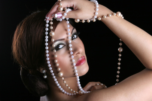 A woman wearing a beautiful pearl necklace