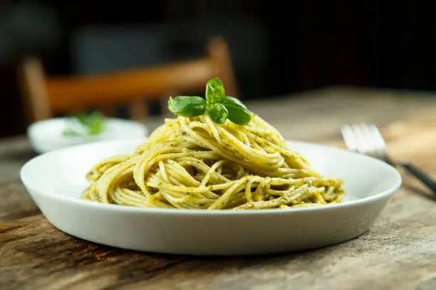 Spaghetti with green basil pesto sauce
