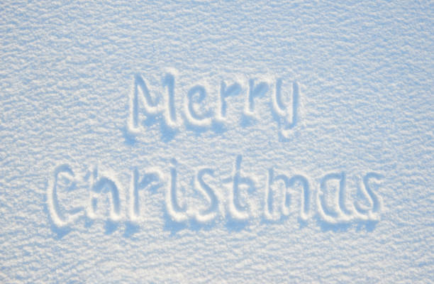 istock Merry christmas text written on snow for texture or background - winter holiday concept. Sunny day, bright light with shadows, flat lay, top view, clean and nobody 913676514