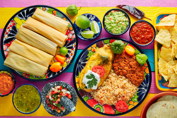 tamale with corn leaf and filled chili pepper - guacamole avocado mexican culture food imagens e fotografias de stock