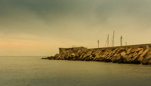 istock Sunset on a beach in Blanes, where you can see the wall breakwater 913677974