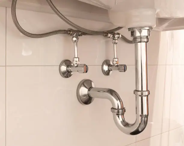 Photo of Basin siphon or sink drain in a bathroom
