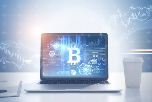 istock Laptop bitcoin symbol and graph, desk, coffee cup 913679038