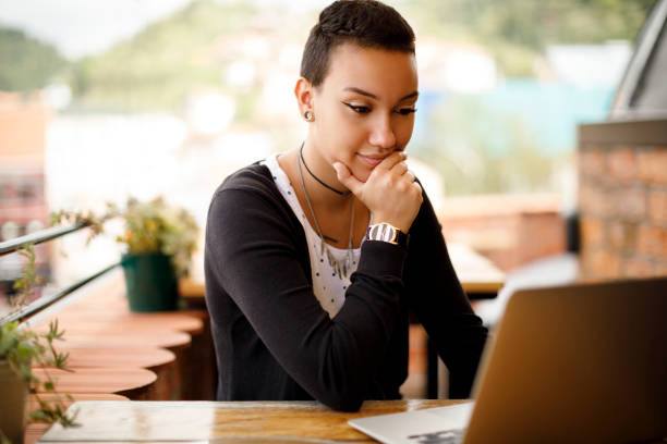 istock Young woman using laptop at a cafe 913679224