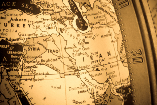Cross-processed closeup shot of the Middle East region on an old globe. The longitudinal metal bar can be seen to the right of the image.