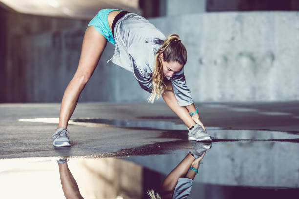 istock Female Athlete Stretching Outdoors 913682070