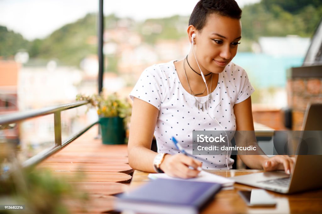 Studying at rooftop cafe Learning Stock Photo