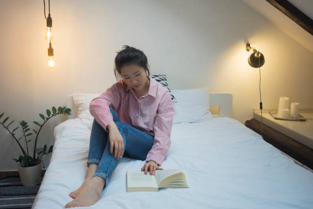 istock Young Chinese woman reading book 913682618