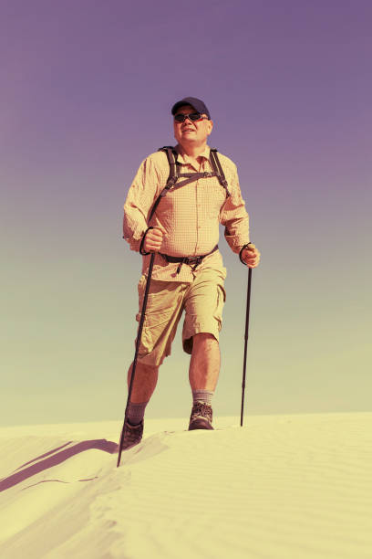 istock Journey through the desert with a backpack and tent. The tent is on a sandy crest. 913686158