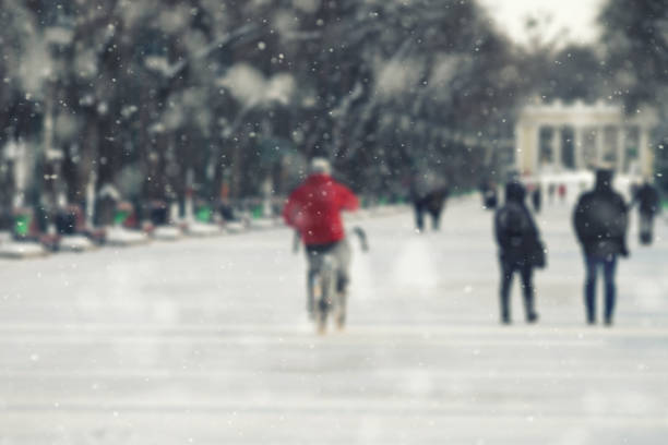 istock Winter landscape park, man on a bicycle, blurred background, tree branches covered with snow, winter background 913688394